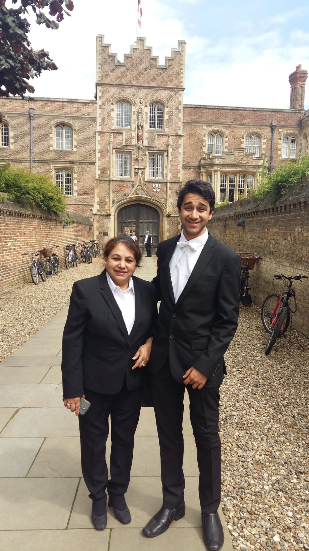 Deep Biswas in formal Cambridge dress with his mother.